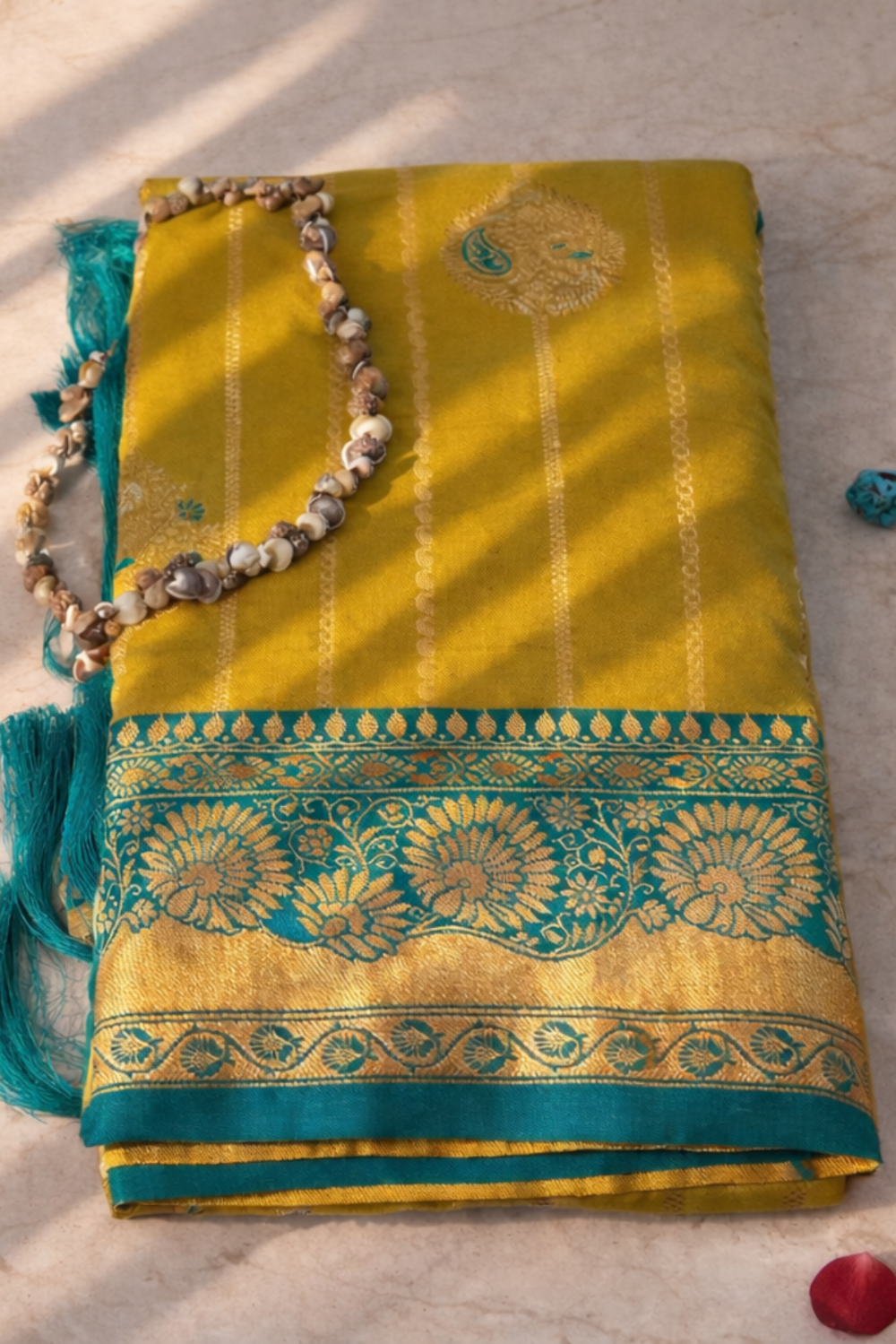 green saree with green border on a textured surface with embroidary